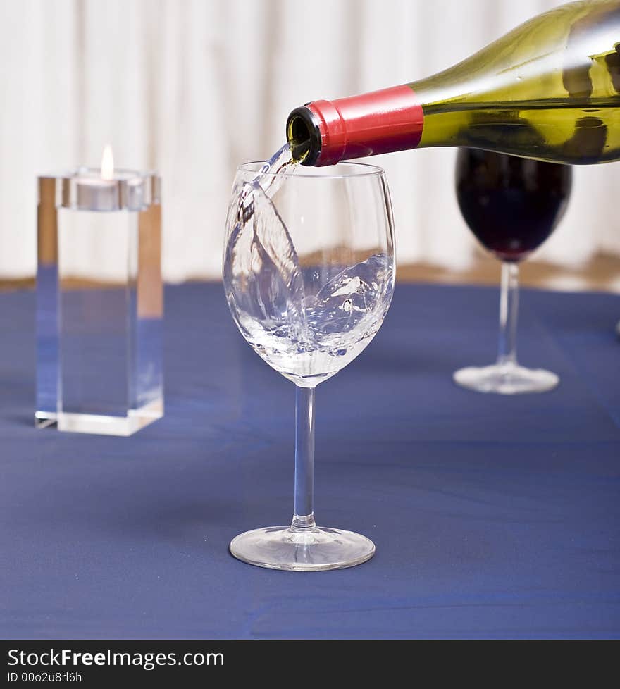 Pouring water in a glass (restaurant scene). Pouring water in a glass (restaurant scene).