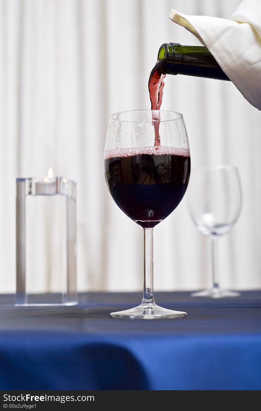 Filling glass with red wine