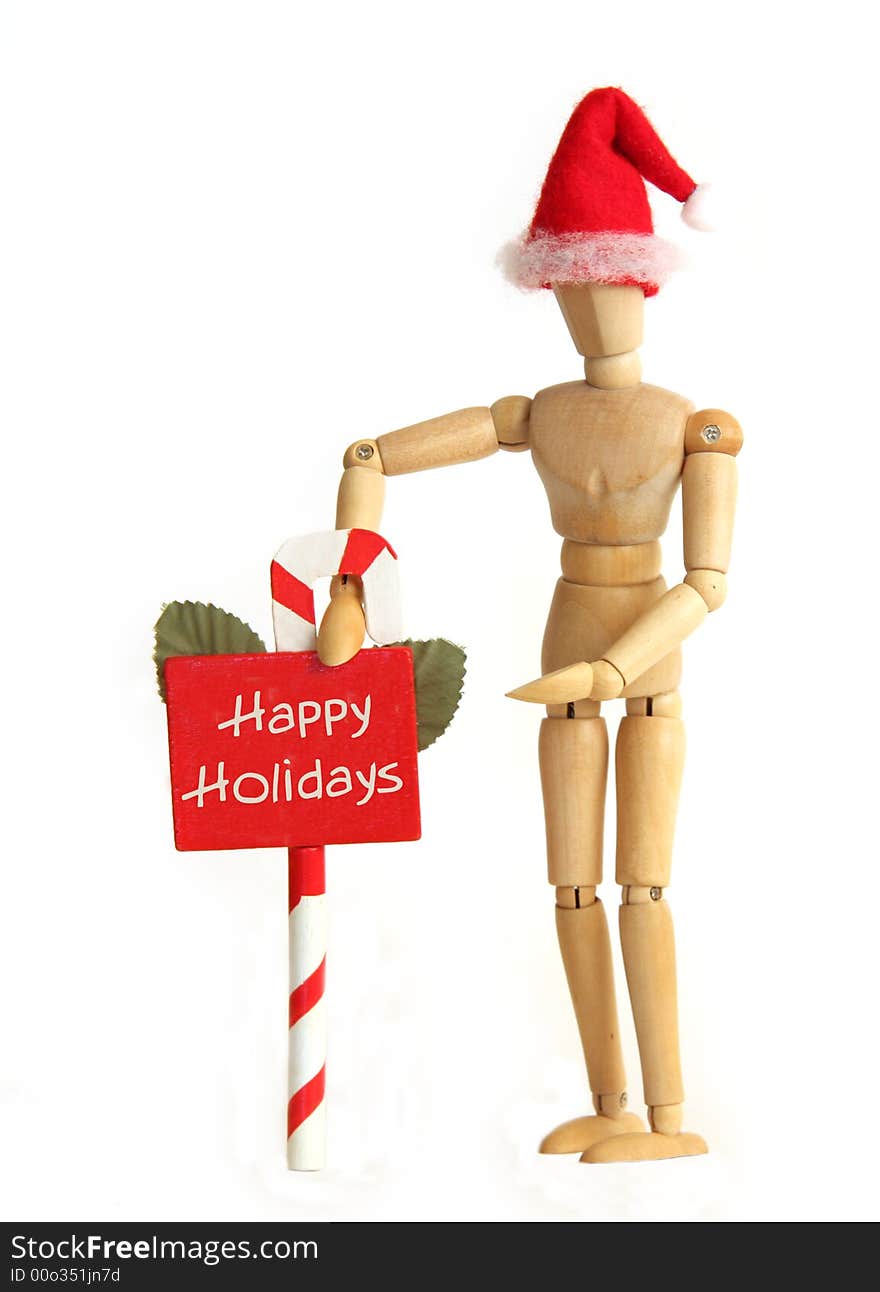 Wooden figurine holding Happy Holiday sign. Wooden figurine holding Happy Holiday sign.