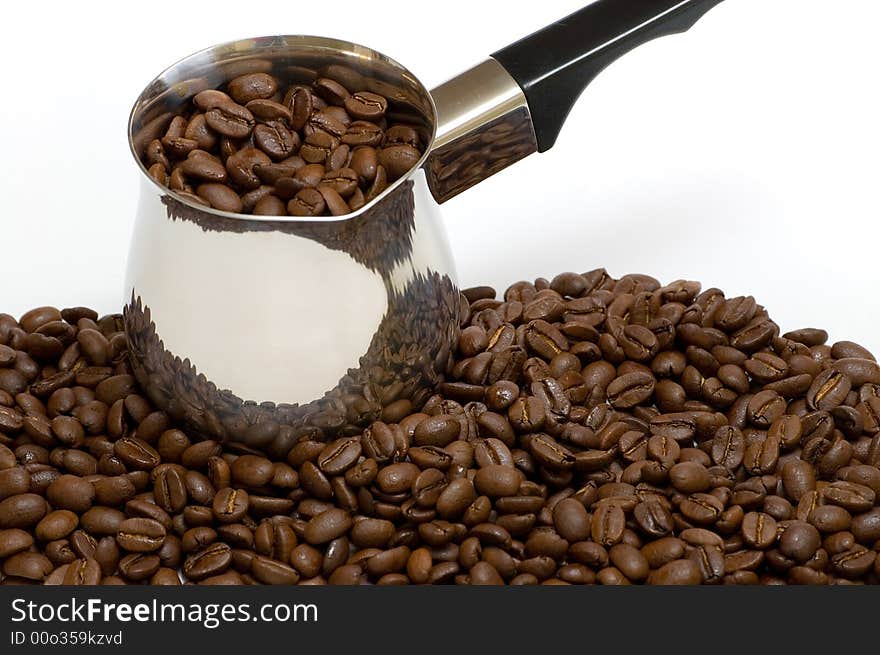 A few coffee beans with a coffee boiler. A few coffee beans with a coffee boiler