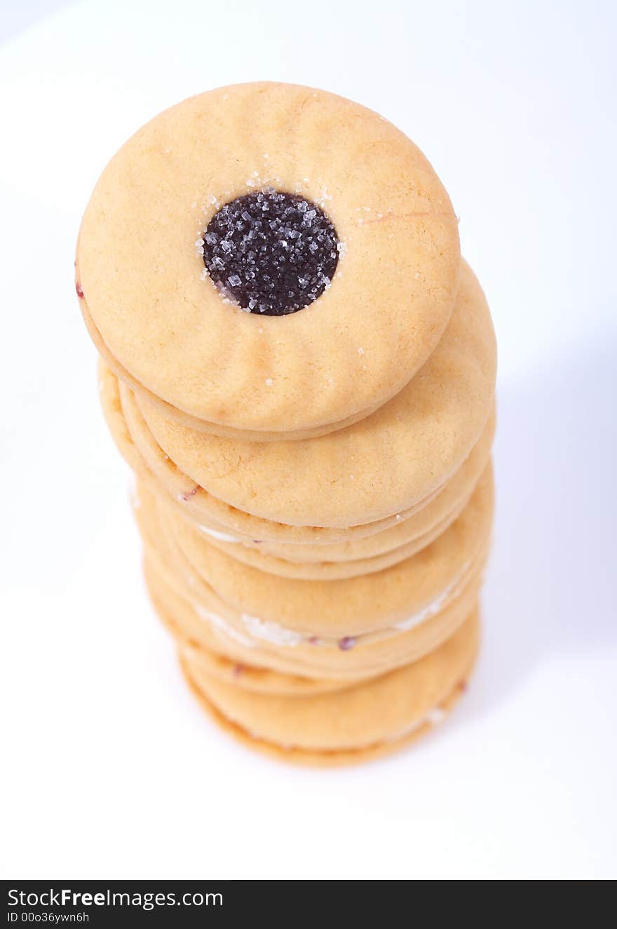 Stack of sweet biscuits over a white background