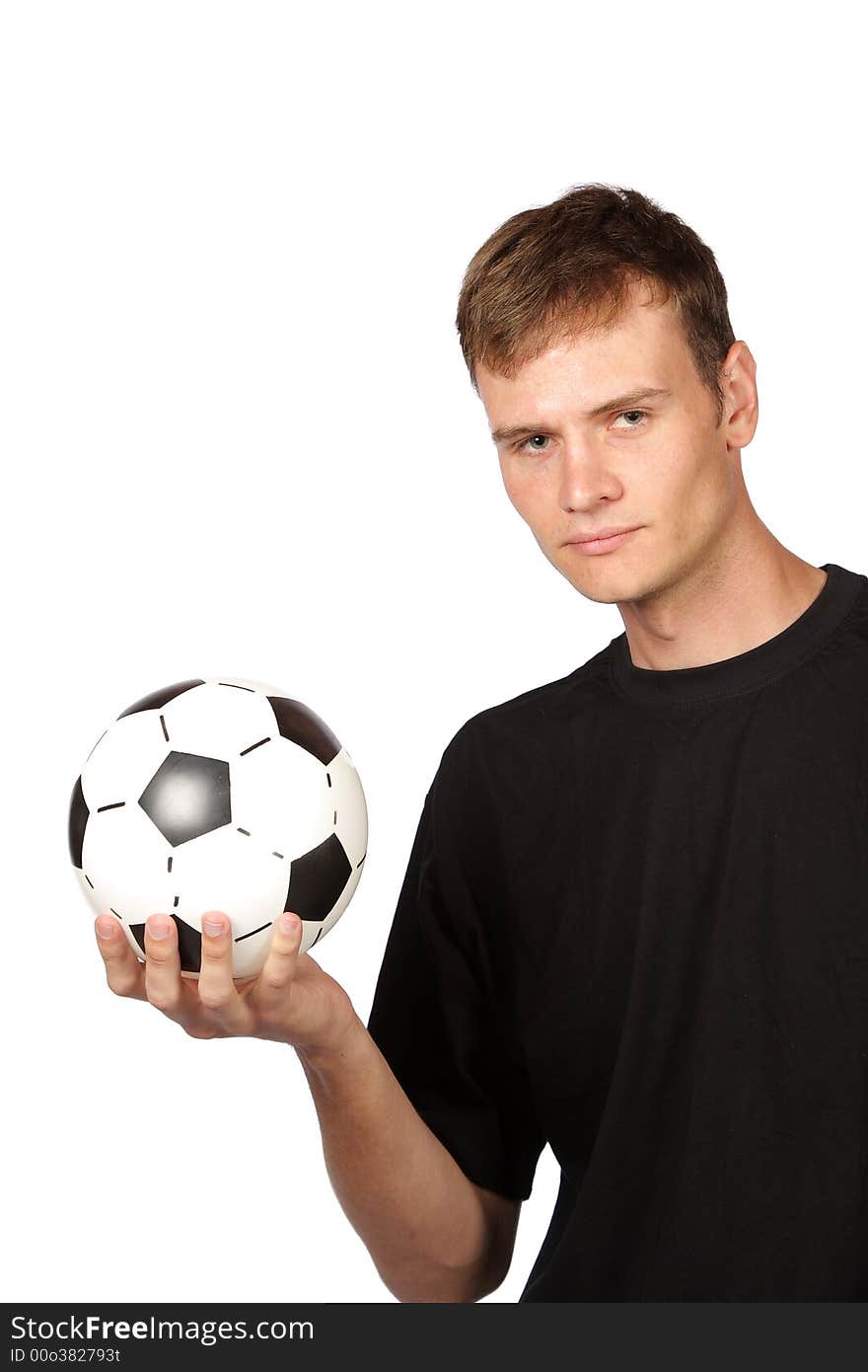 Football player holding soccer ball in one hand