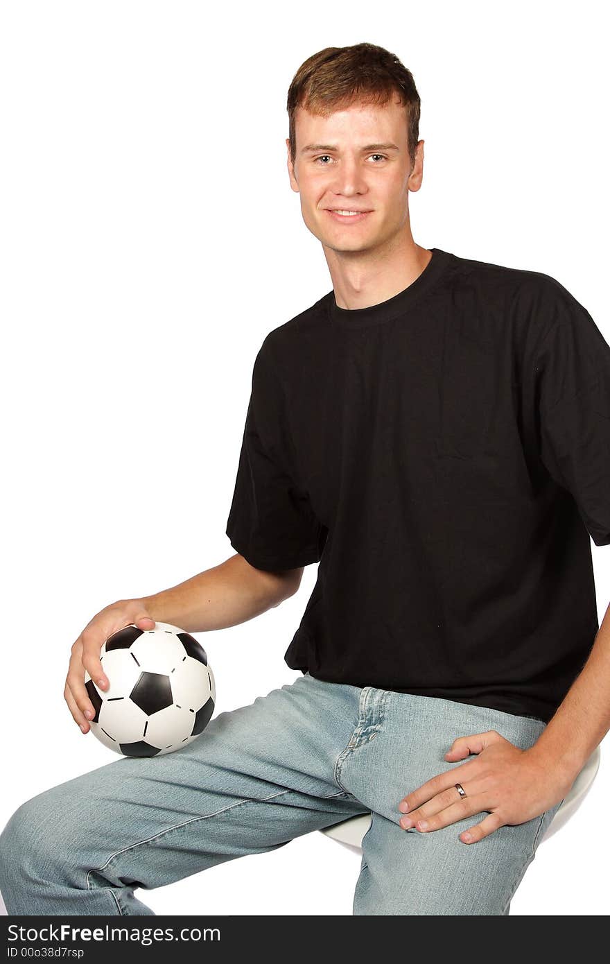 Football player in denim with ball in lap. Football player in denim with ball in lap