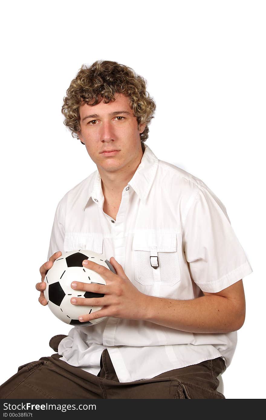 Soccer player sitting with football in his hands. Soccer player sitting with football in his hands