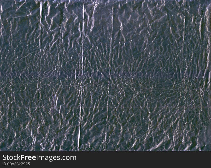 A flattened piece of silver wrapping foil, suitable as a background texture.