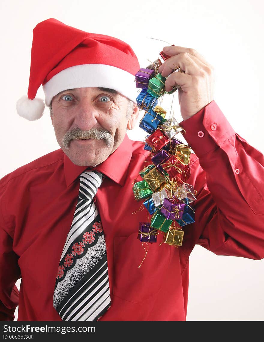 Businessman with Christmas gift and Santa Claus hat. Businessman with Christmas gift and Santa Claus hat.