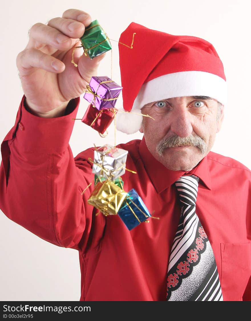 Businessman with Christmas gift and Santa Claus hat. Businessman with Christmas gift and Santa Claus hat.