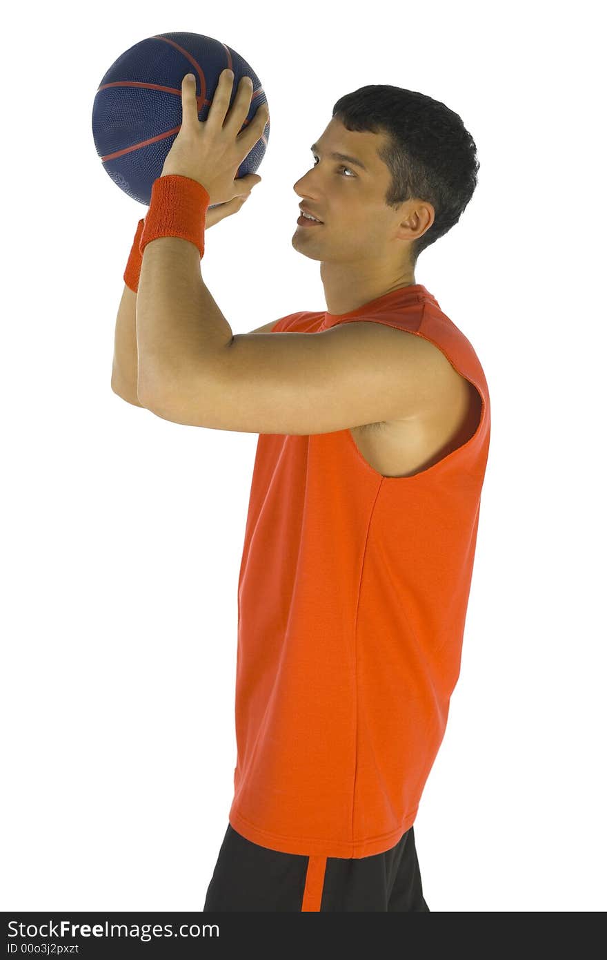 Young man preparing to throw basketball. White background, side view. Young man preparing to throw basketball. White background, side view.