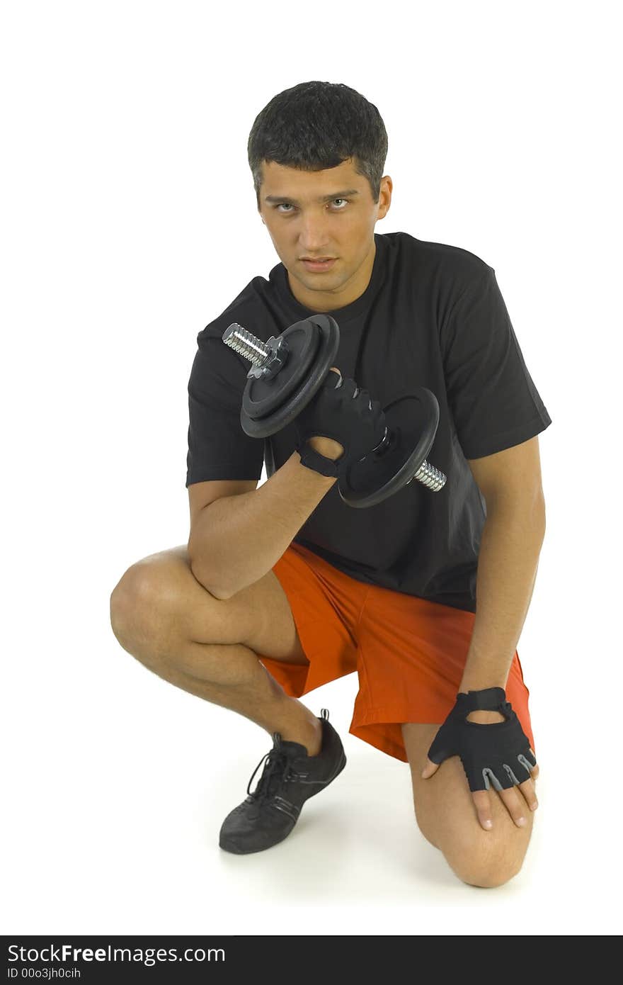 Young man exercising with dumbbell. Isolated on white background. Looking at camera, front view.