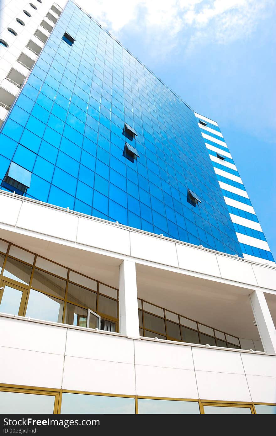 Modern business center reflect blue cloudy sky