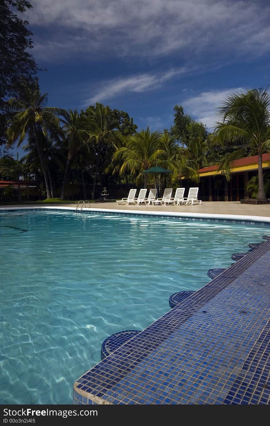 Luxury infinity swimming pool with raft float caribbean sea resort hotel with palm trees nicaragua. Luxury infinity swimming pool with raft float caribbean sea resort hotel with palm trees nicaragua