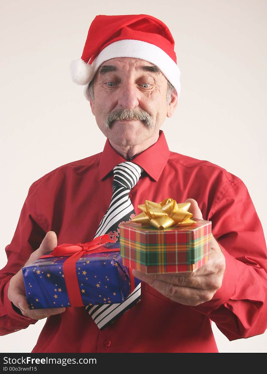 Businessman with Christmas gift and Santa Claus hat. Businessman with Christmas gift and Santa Claus hat.