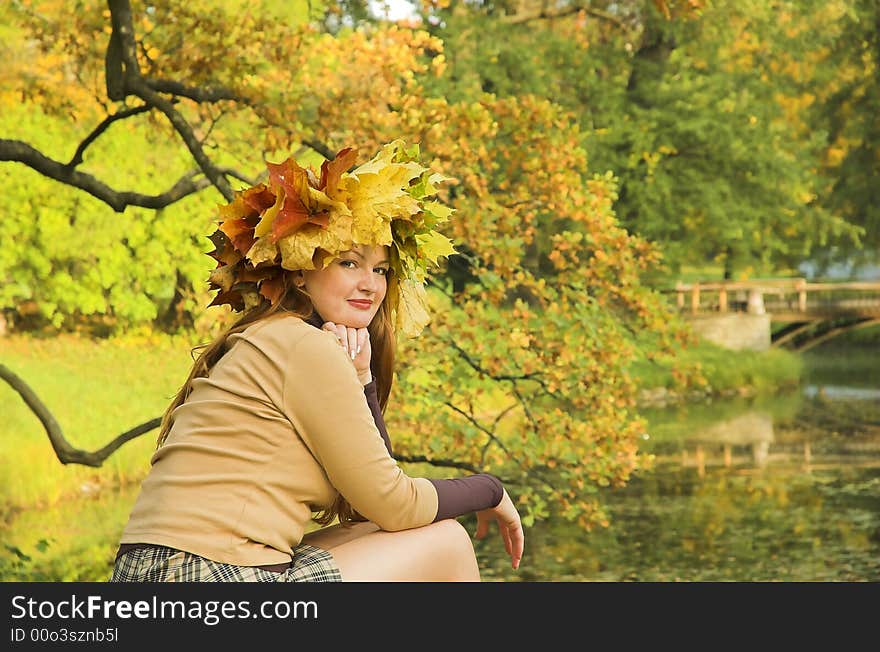 Portrait of the girl in a wreath from maple leaves