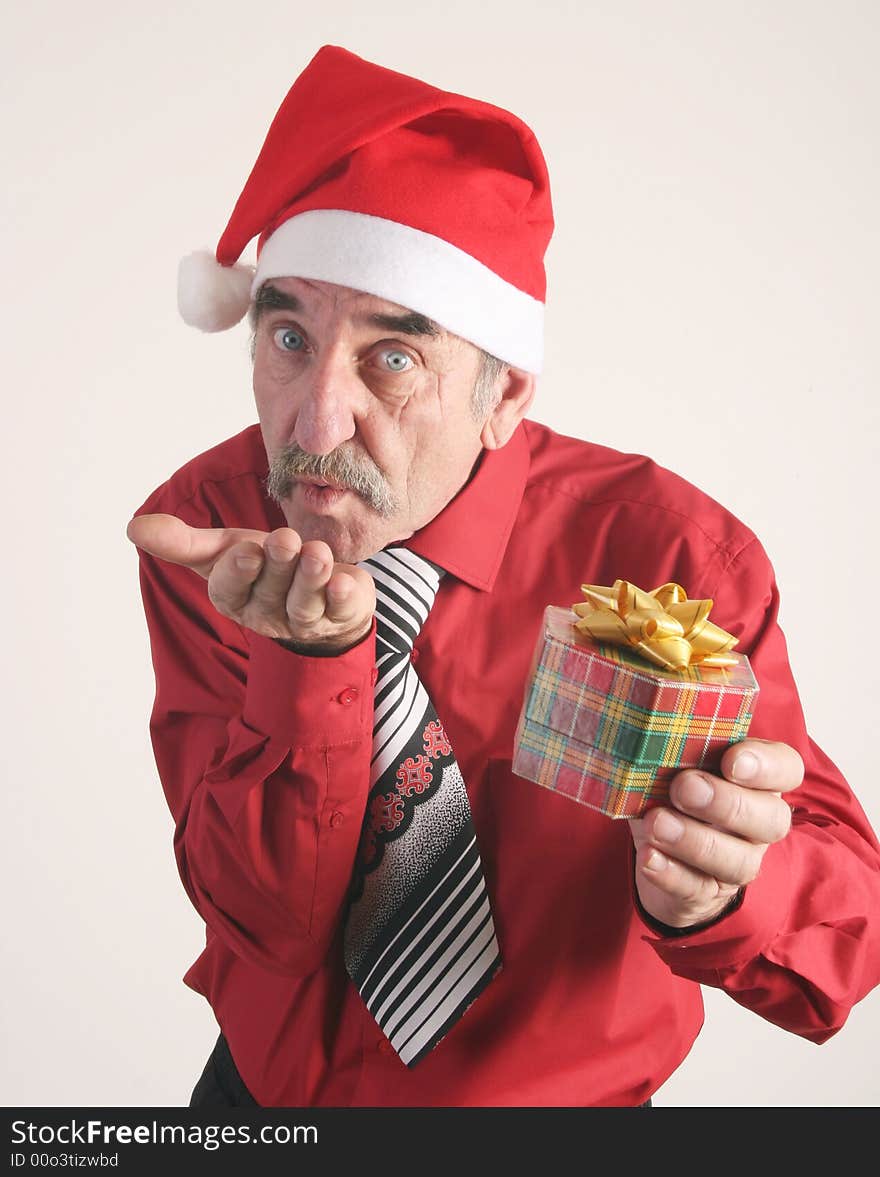 Businessman with Christmas gift and Santa Claus hat. Businessman with Christmas gift and Santa Claus hat.