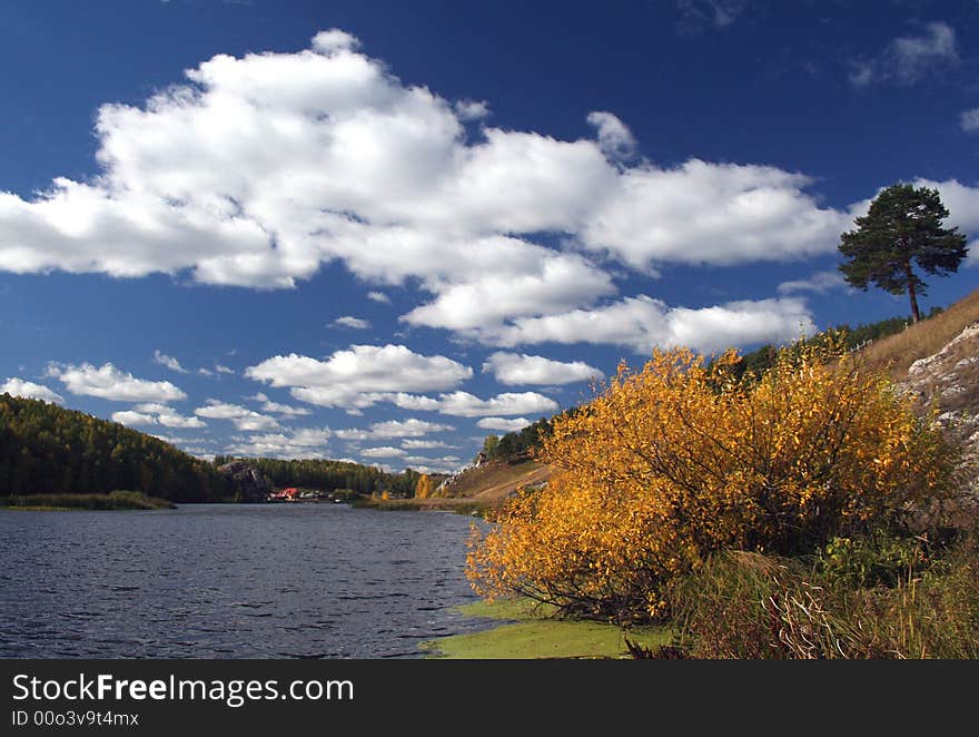 Autumn lansdcape with the clouds and the Russian river Iset