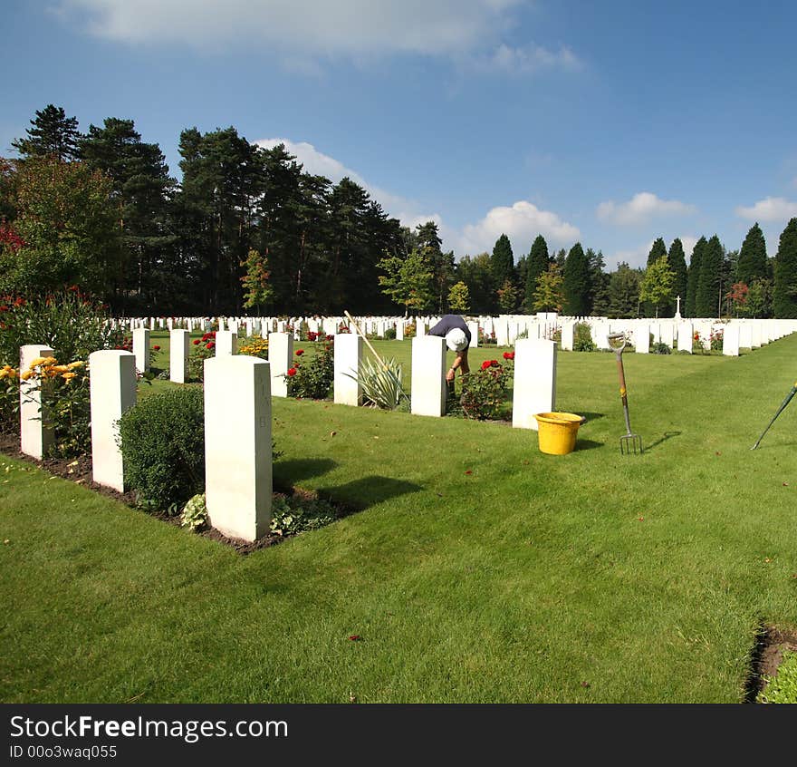 Gardener working in a Miltary Cemetery in England. Gardener working in a Miltary Cemetery in England