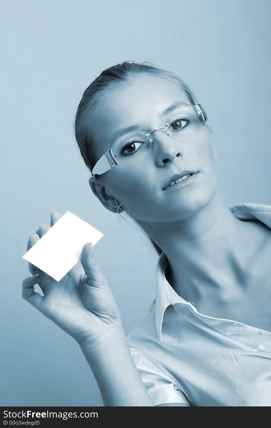 Business portrait of a young and successful woman with a businesscard in her hand. Business portrait of a young and successful woman with a businesscard in her hand