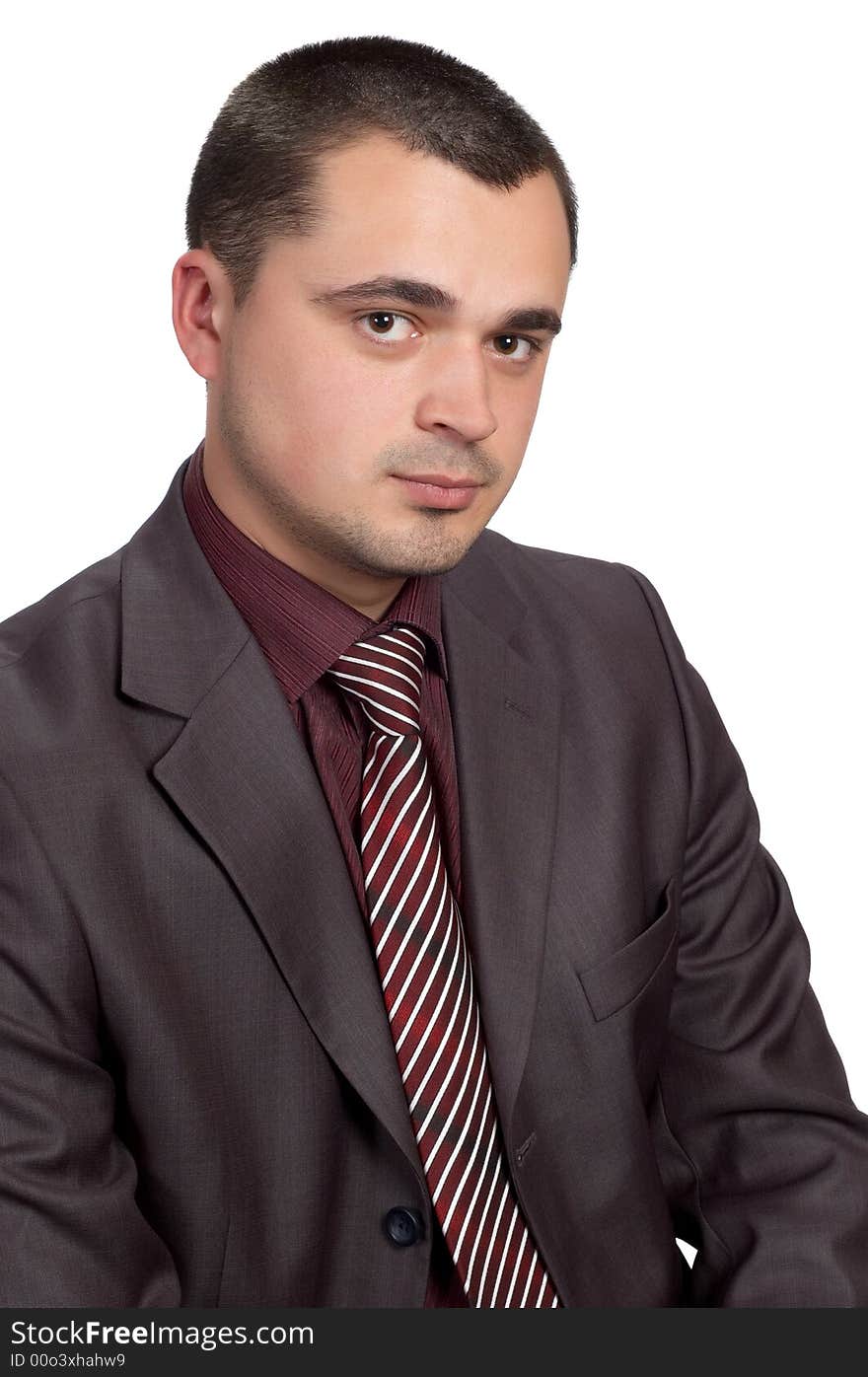 Young businessman in shimmering suit and red shirt