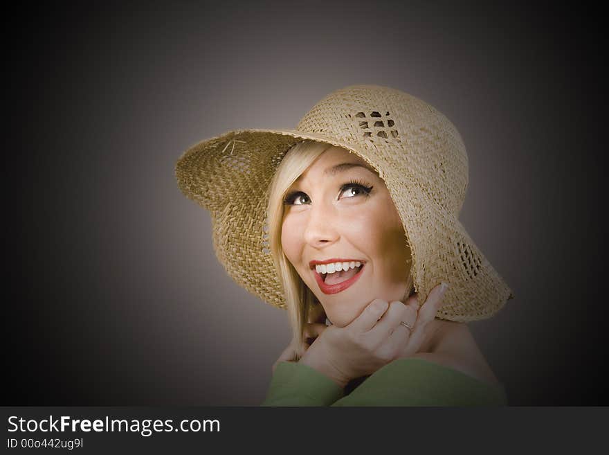 Blonde Model in straw hat under spotlight. Blonde Model in straw hat under spotlight