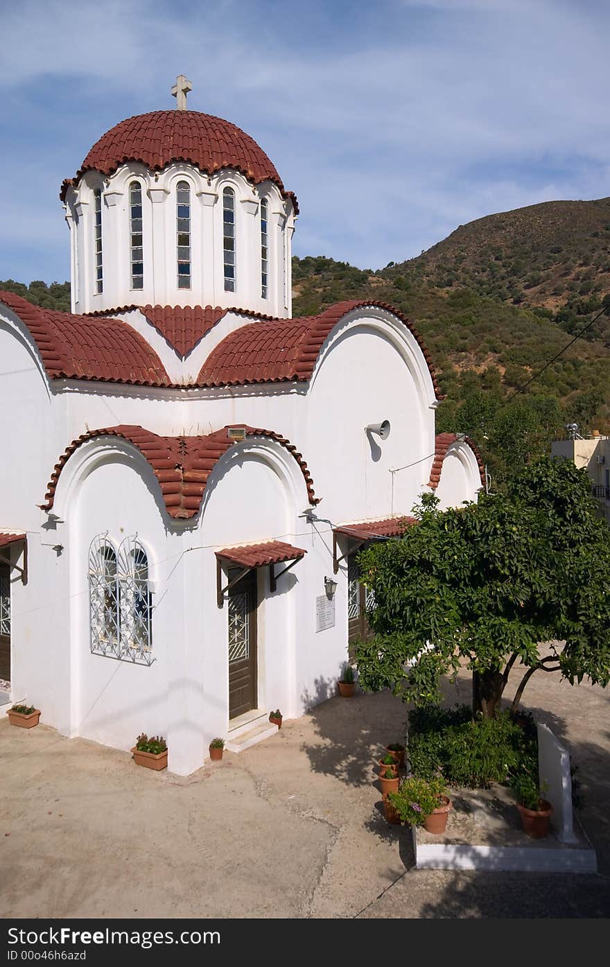 White church with cross on dome under blue sky