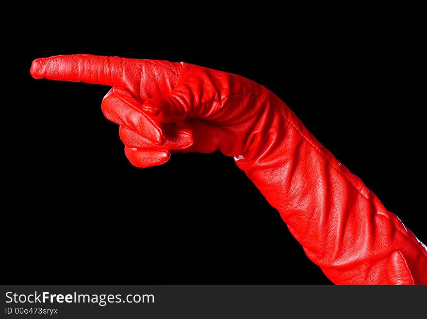 Hand in red glove on the black background showing the left order