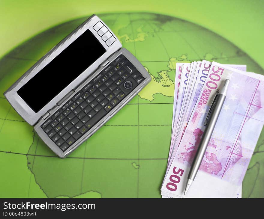 Personal agenda and money on globe wallpaper. Personal agenda and money on globe wallpaper