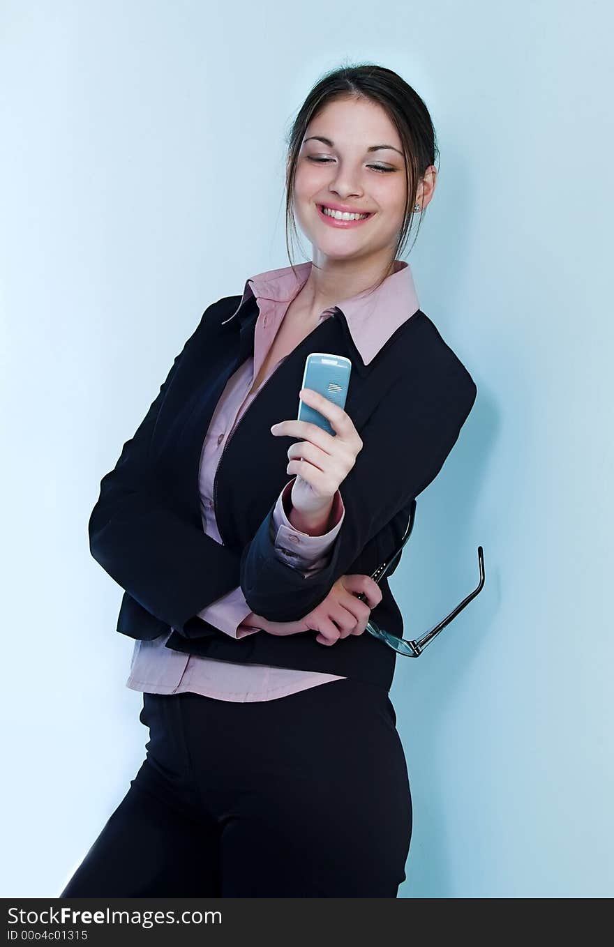 Pretty secretary held mobile phone and eyeglasses