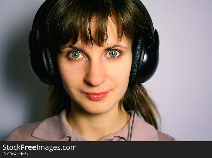 Woman with headphones is listening to music