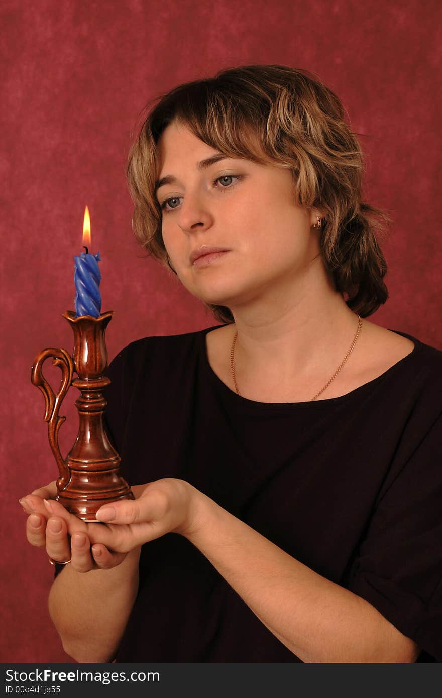 Portrait of the girl with a burning candle