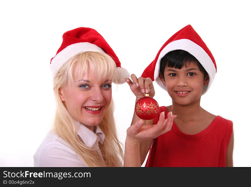 Cute little asian boy as santa claus giving a present to blond pretty girl. Cute little asian boy as santa claus giving a present to blond pretty girl