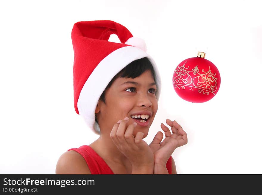 Cute little asian boy as santa claus watching the baubles. Cute little asian boy as santa claus watching the baubles