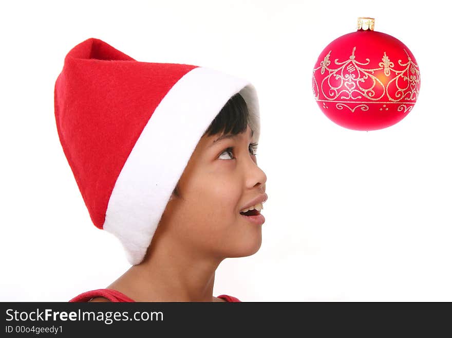 Cute little asian boy as santa claus watching the baubles. Cute little asian boy as santa claus watching the baubles