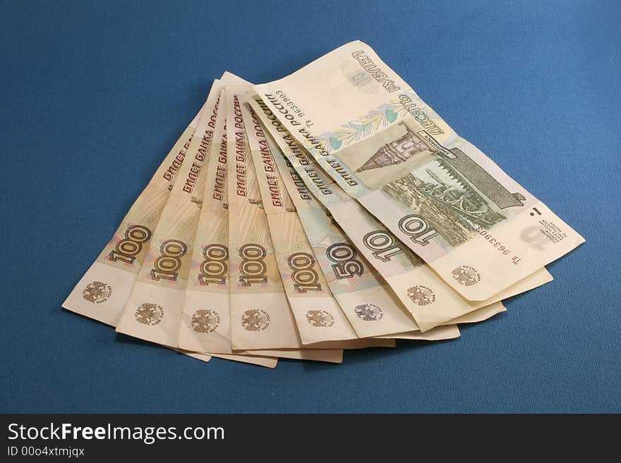 Some Russian cash in a fan shape on a blue background. Some Russian cash in a fan shape on a blue background