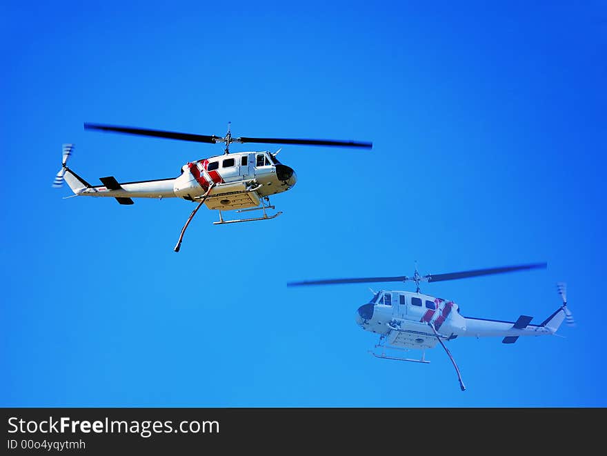 Helicopter making water drops for the firemen on the ground battling California wildfires in Los Angeles. Helicopter making water drops for the firemen on the ground battling California wildfires in Los Angeles.