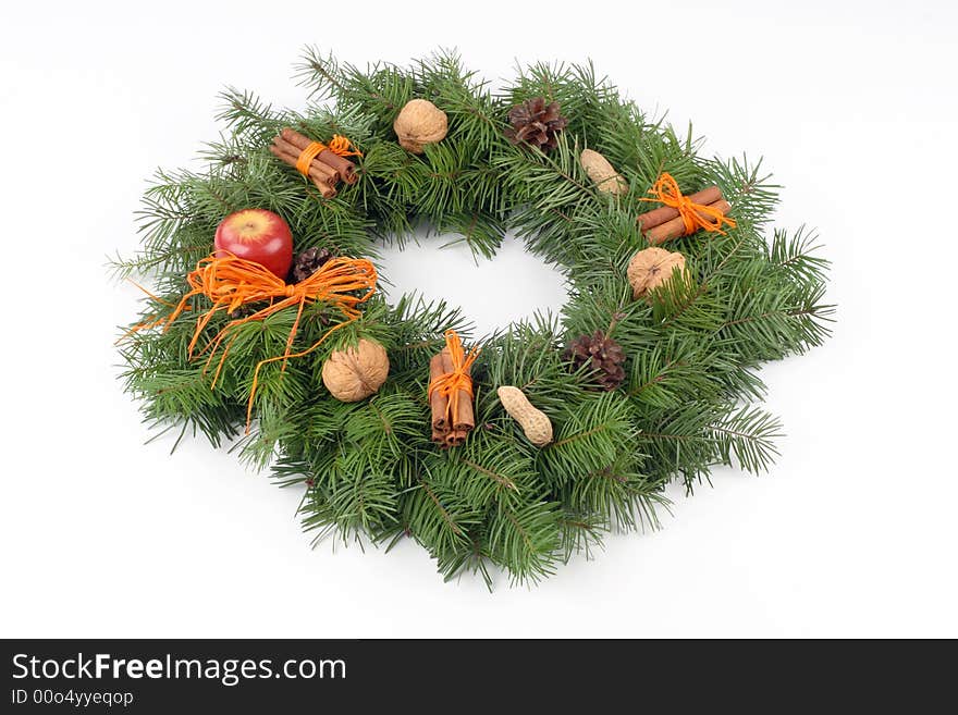 Advent wreath with orange bast, nuts, cones