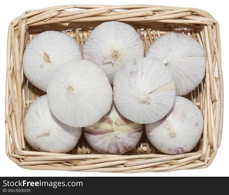 Isolated one clove per head garlic in a basket. Isolated one clove per head garlic in a basket.