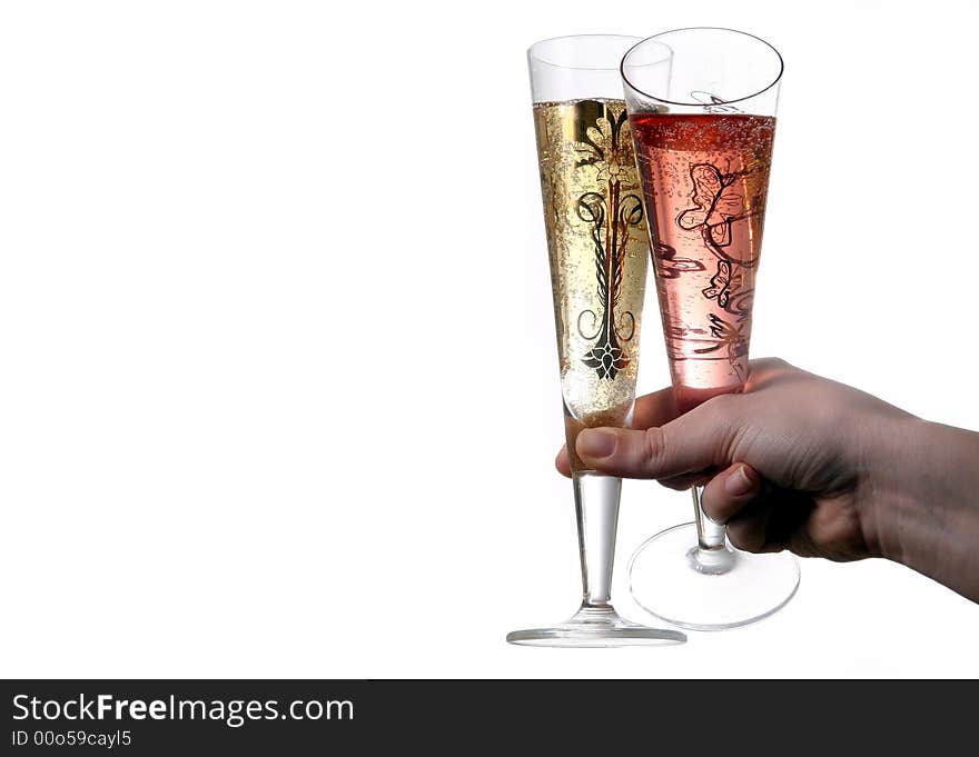 Pair of red and gold champagne flutes making a with bubbles held by hand. Isolated on white space (for text). Pair of red and gold champagne flutes making a with bubbles held by hand. Isolated on white space (for text).