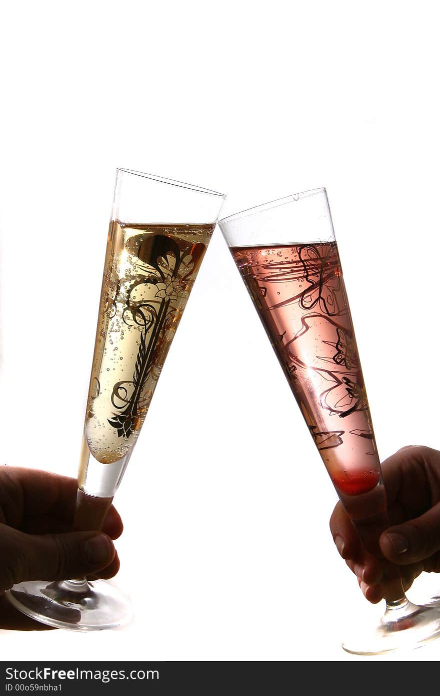 Pair of red and gold champagne flutes making a with bubbles held by hand. Isolated on white space (for text). Pair of red and gold champagne flutes making a with bubbles held by hand. Isolated on white space (for text).