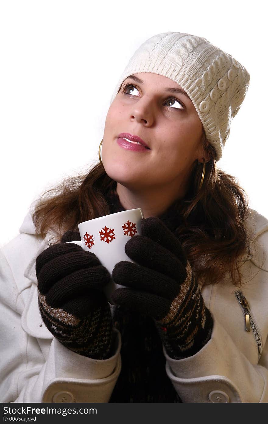 A young woman holding a cup of tea in winterclothes. Isolated over white space (for text). A young woman holding a cup of tea in winterclothes. Isolated over white space (for text).