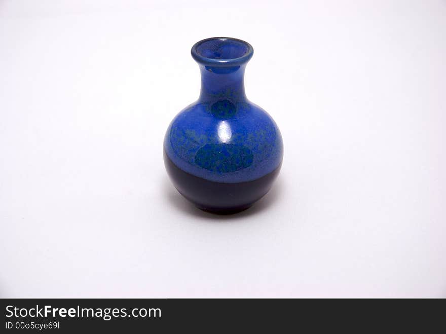 A blue ceramic bottle on a white background