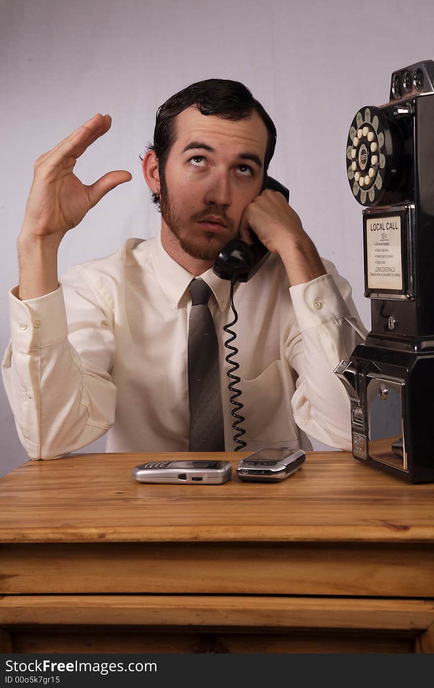 Young businessman dealing with too many phones. Young businessman dealing with too many phones