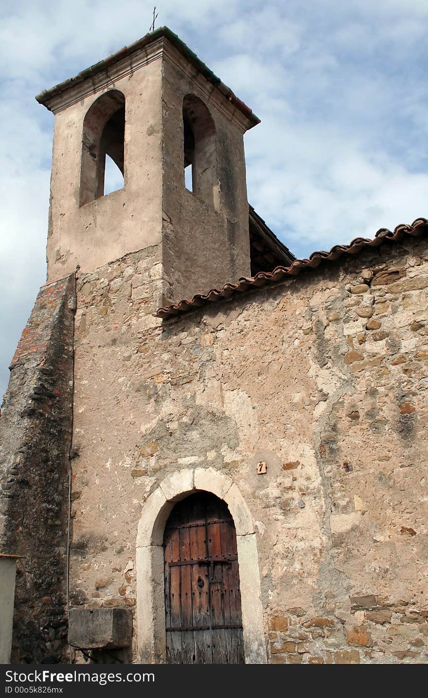 Abandoned church made of stones with a wood door in Besalu, Spain.