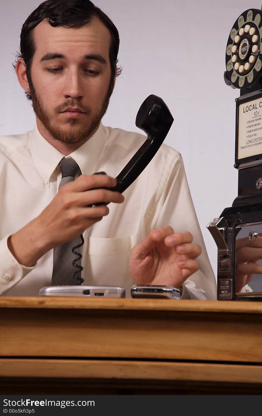 Young businessman dealing with too many phones. Young businessman dealing with too many phones