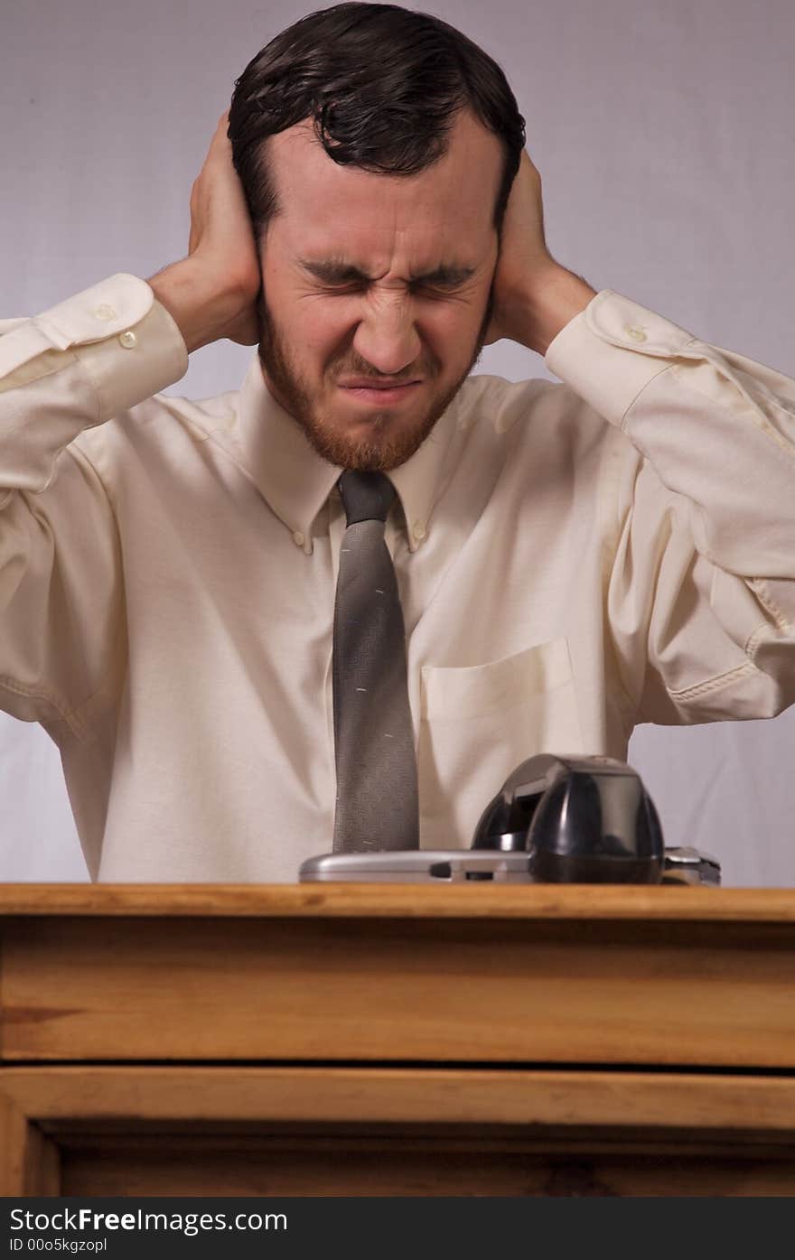 Young businessman dealing with too many phones. Young businessman dealing with too many phones