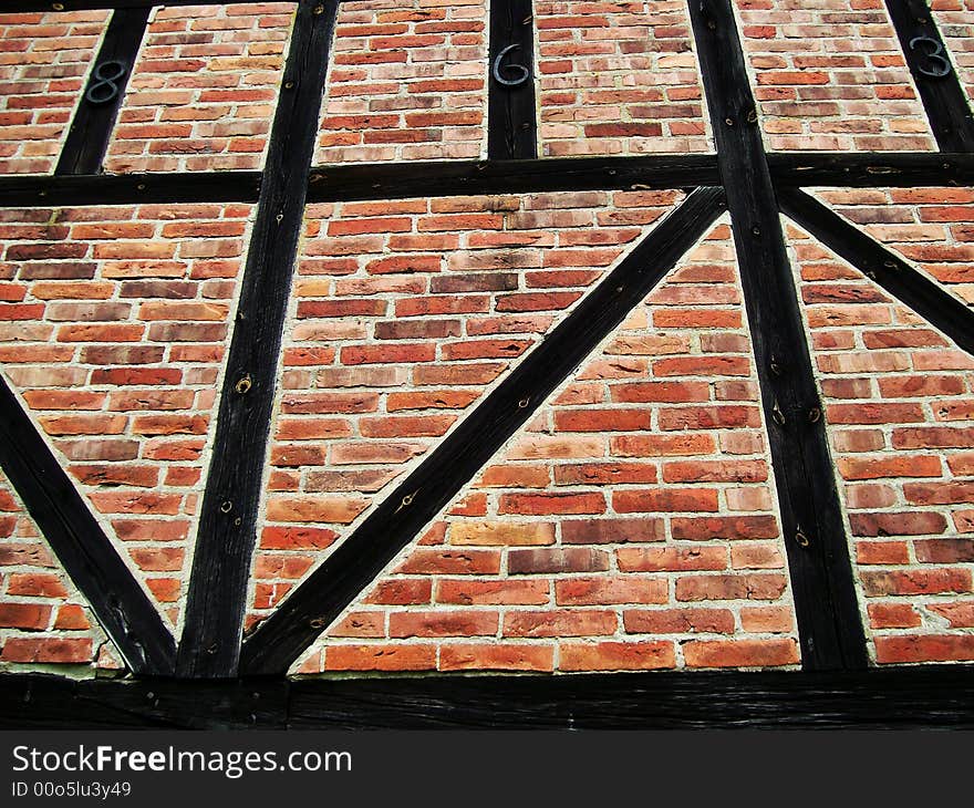 An image of a brick wall with wooden beams. An image of a brick wall with wooden beams