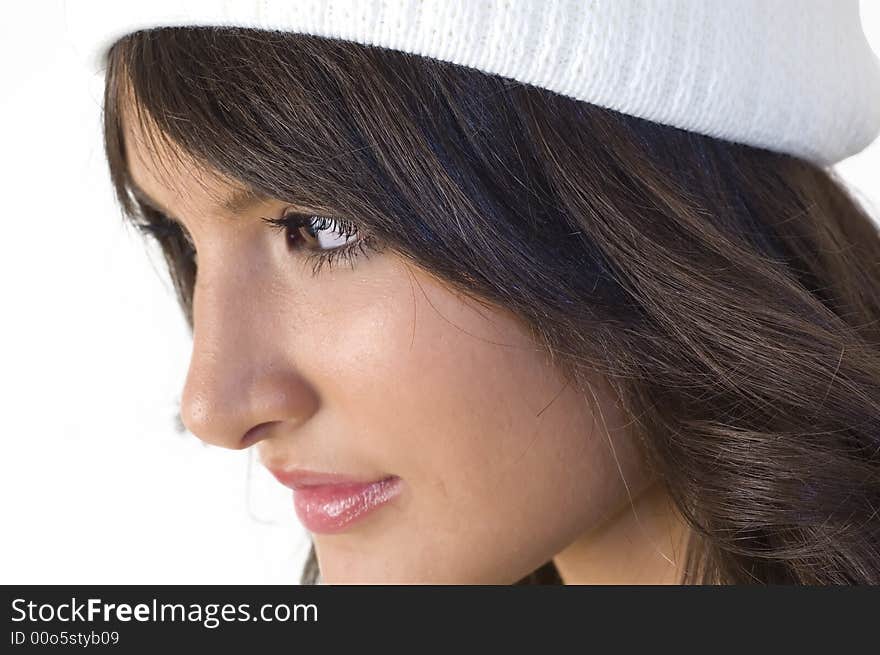 Portrait of young brunette girl with white hood. Winter clothing.