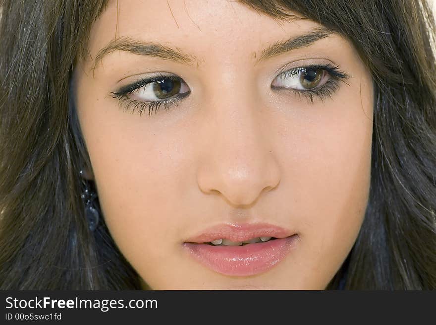 Portrait of young brunette girl with beautiful eyes and face.