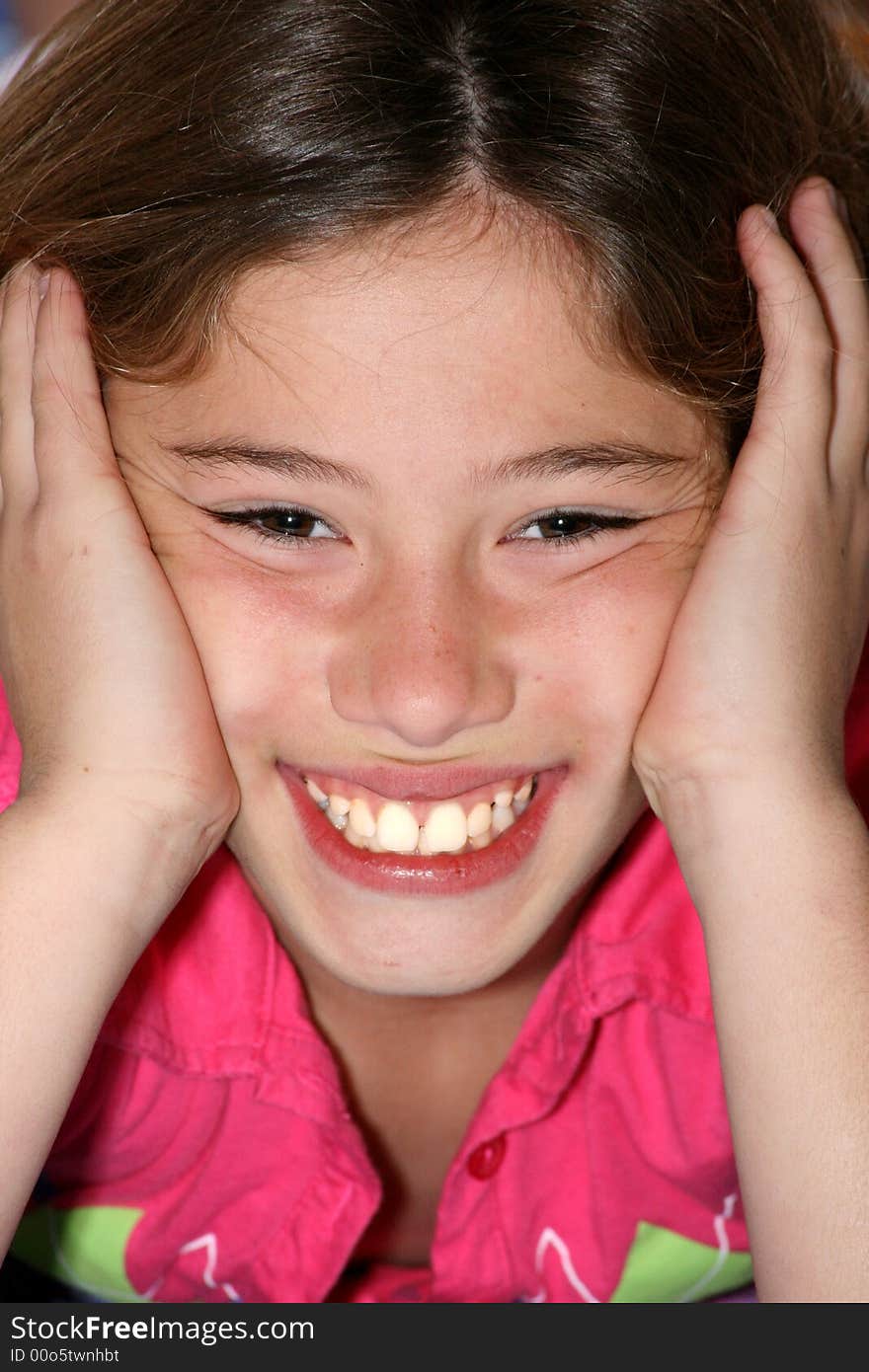 Close-up portrait of young girl with her head propped up in her hands. Close-up portrait of young girl with her head propped up in her hands