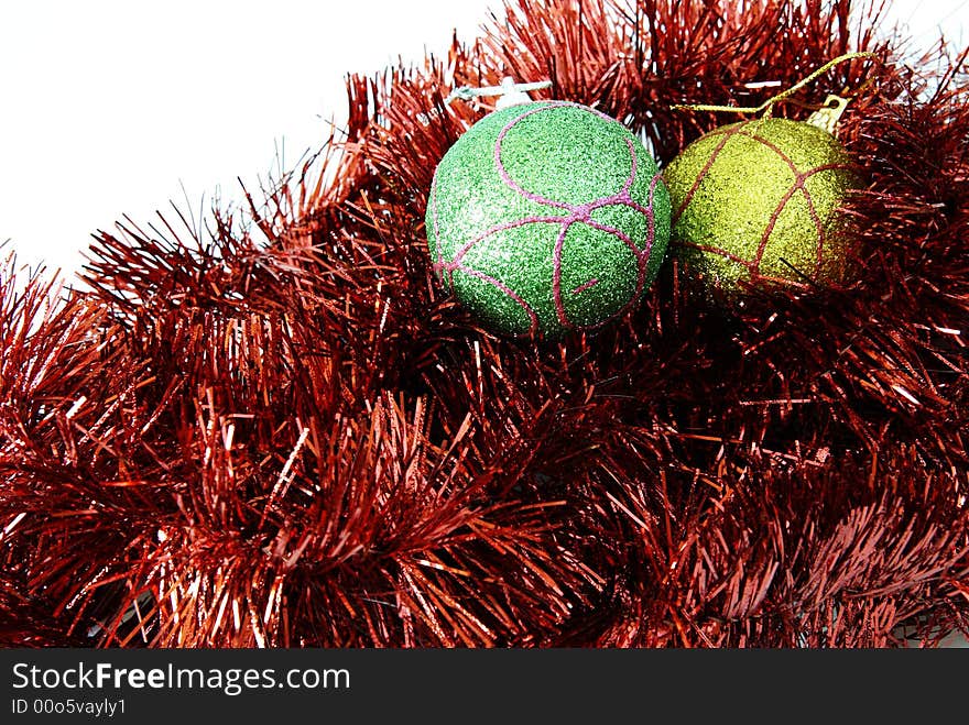 Two bauble balls in red tinsel isolated on a white background