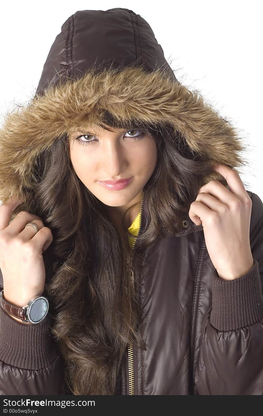 Young brunette girl in brown winter jacket.Happy face and worm look. Young brunette girl in brown winter jacket.Happy face and worm look.